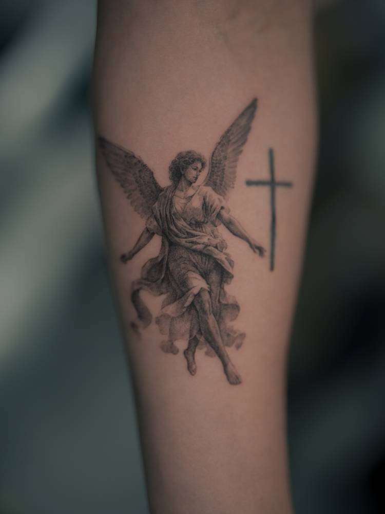 Classical style angel tattoo located on the inner forearm.