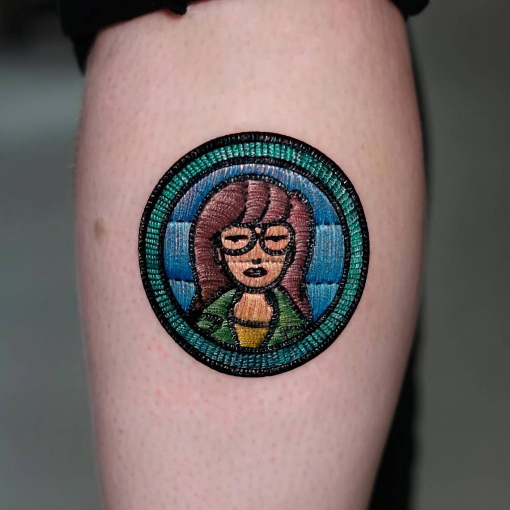 Daria patch tattoo located on the calf, embroidery style.
