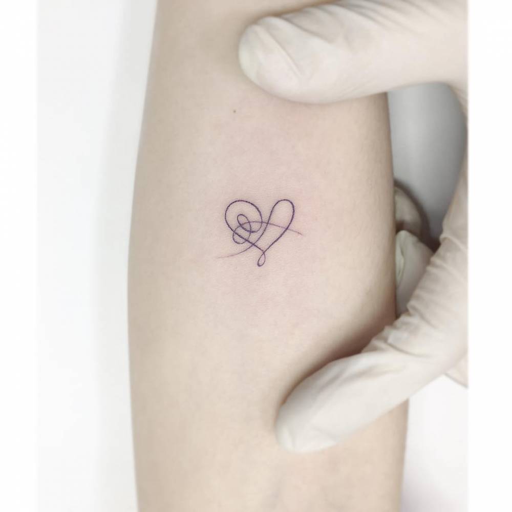 Abstract heart tattoo located on the inner forearm.
