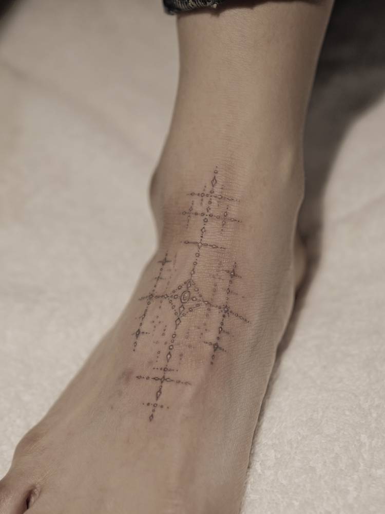 Ornamental design tattoo on the foot.
