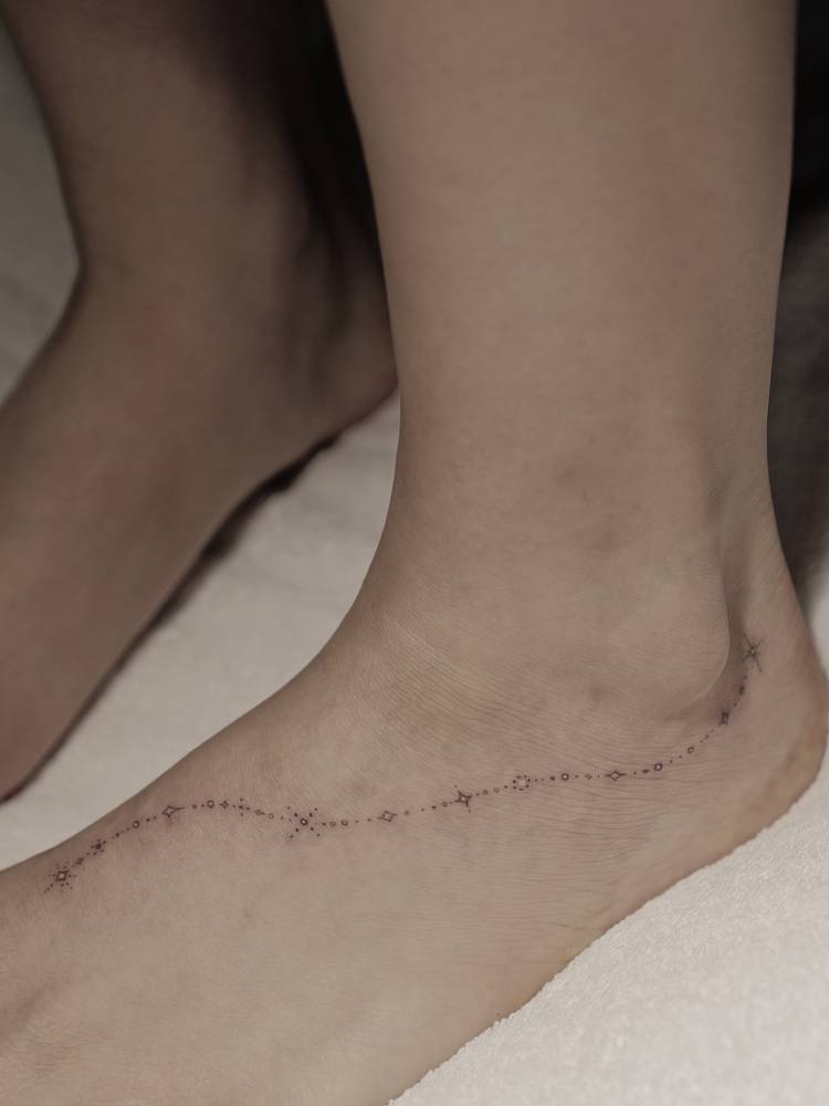 Single needle ornament tattoo done on the foot.