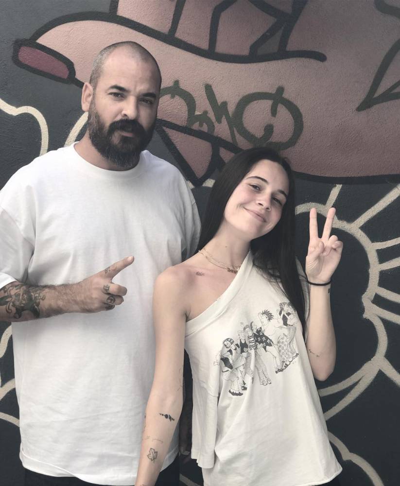 "Peaches" lettering tattoo located on Bea Miller's collarbone.