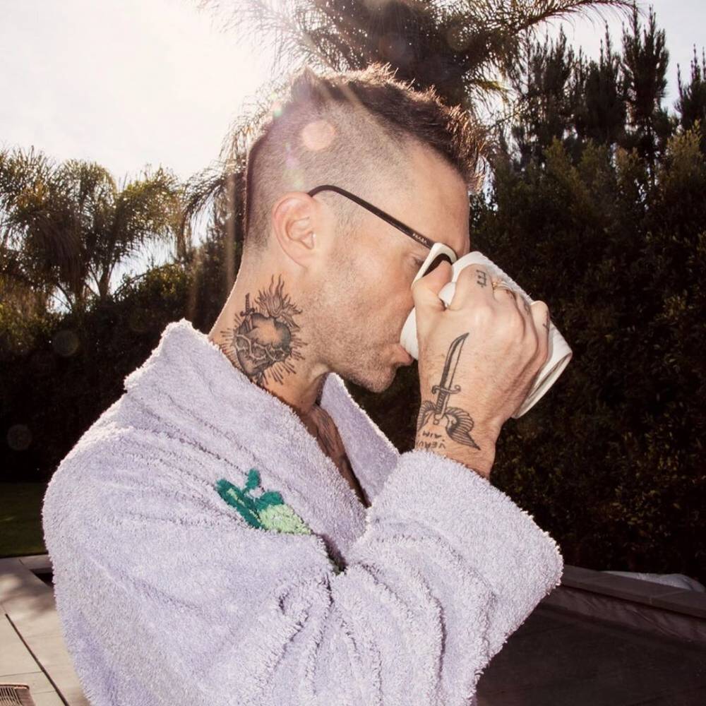 Sacred heart tattoo done on Adam Levine's right side of the neck.