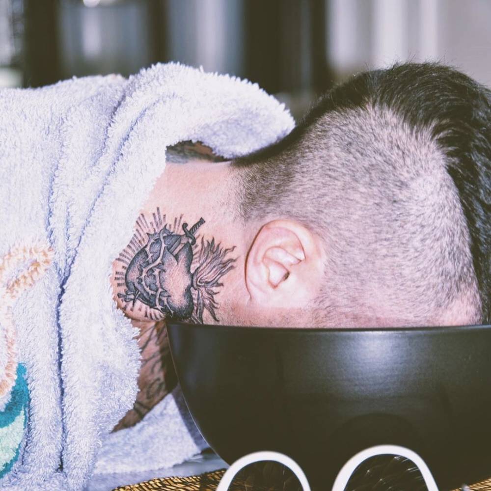 Sacred heart tattoo done on Adam Levine's right side of the neck.