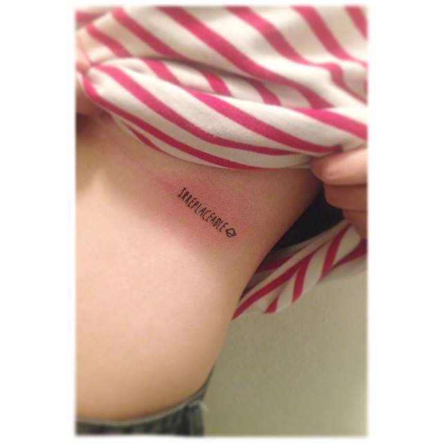 "Irreplaceable" lettering tattoo located on the rib.