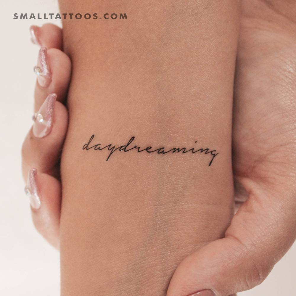 "Daydreaming" temporary lettering tattoo located on the wrist.