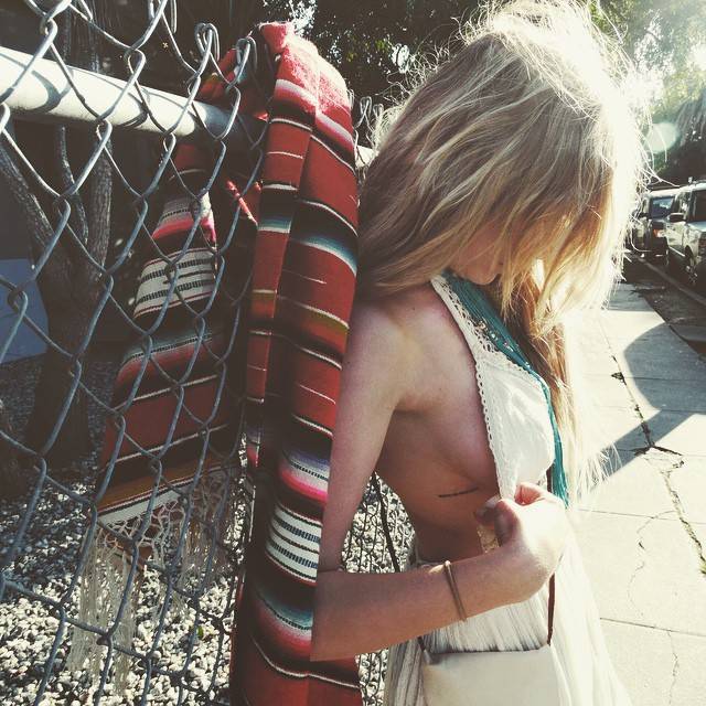 Ashley Benson's side boob lettering tattoo.