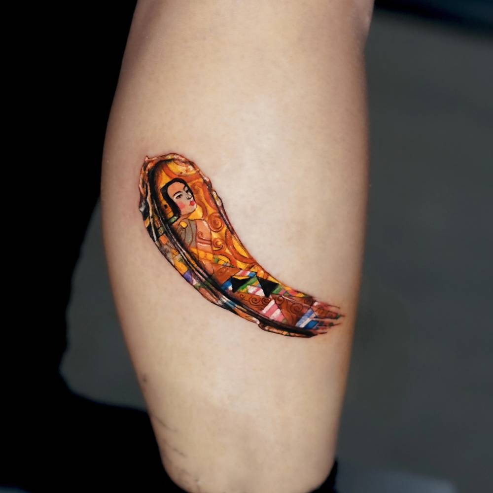 Klimt brushstroke tattoo located on the calf, watercolor style.