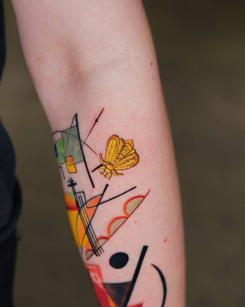 Embroidery style bee tattoo located on the inner forearm.