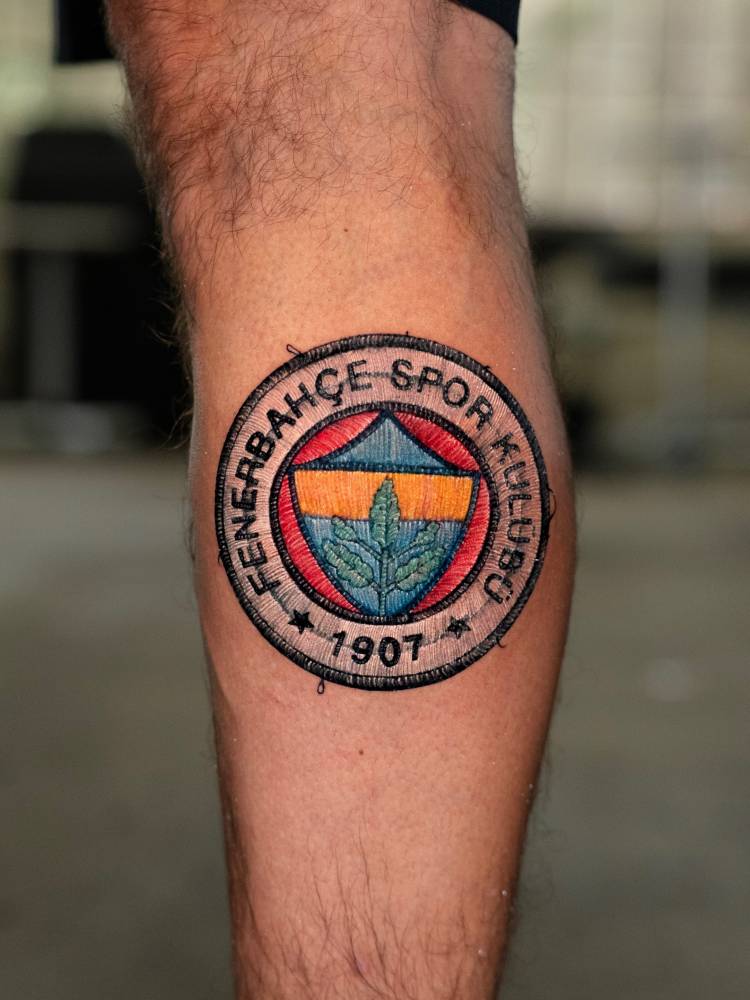 Fenerbahçe S.K. patch tattoo in embroidery style located on the calf.