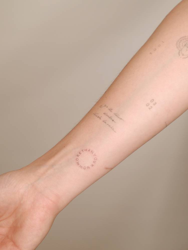 "More than you know" lettering tattoo located on the wrist.