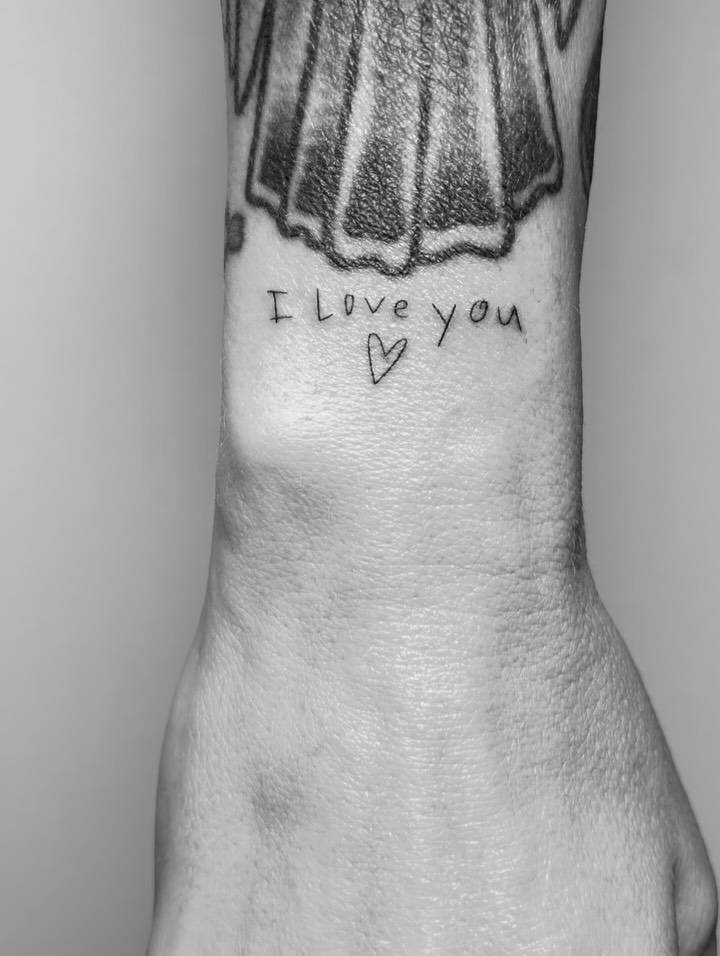 "I love you" in her child's handwriting tattooed on the wrist.