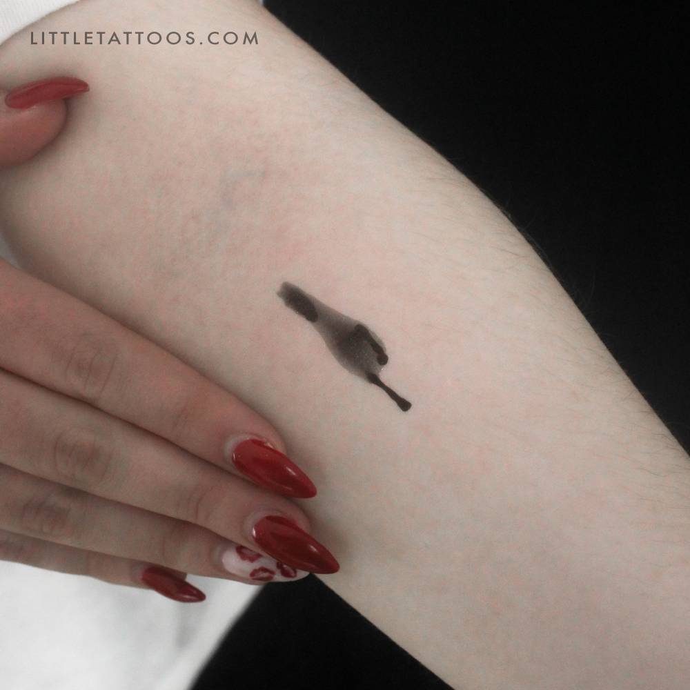 Blurred horse temporary tattoo located on the inner forearm.
