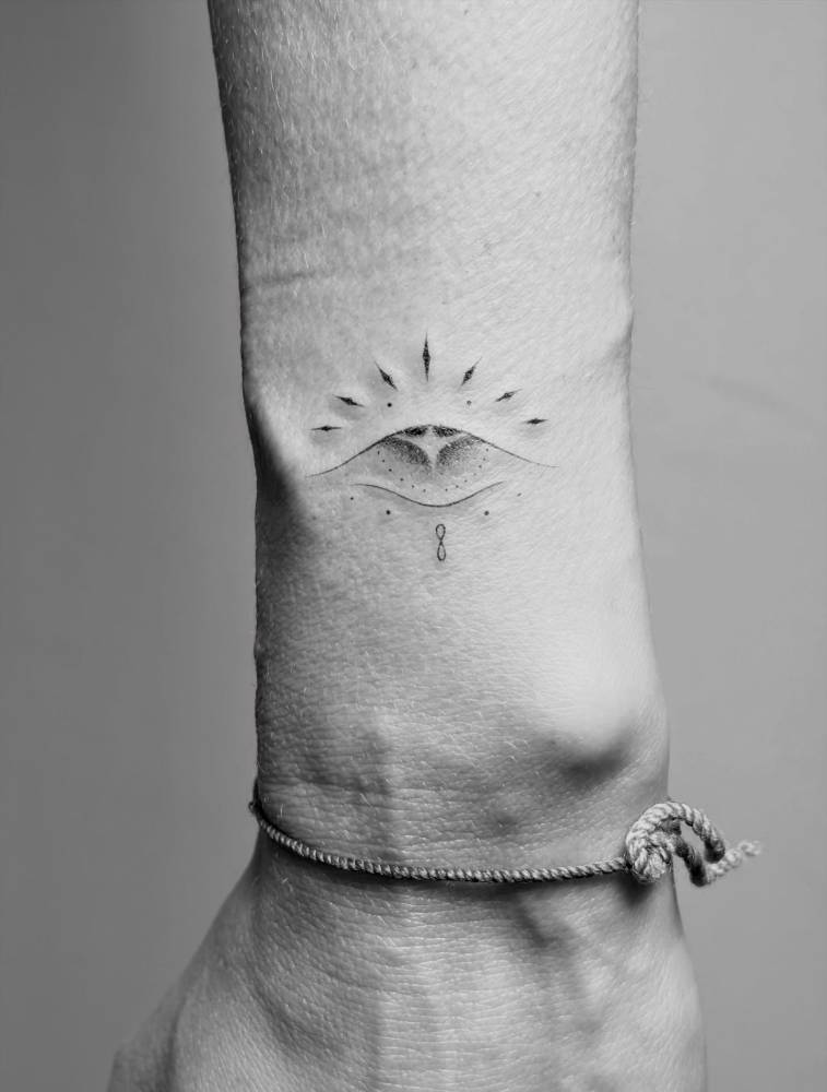 Ornamental evil eye tattoo located on Jessica Alba's wrist.