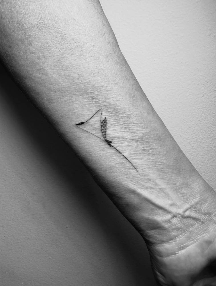Spotted eagle ray tattoo located on the wrist.