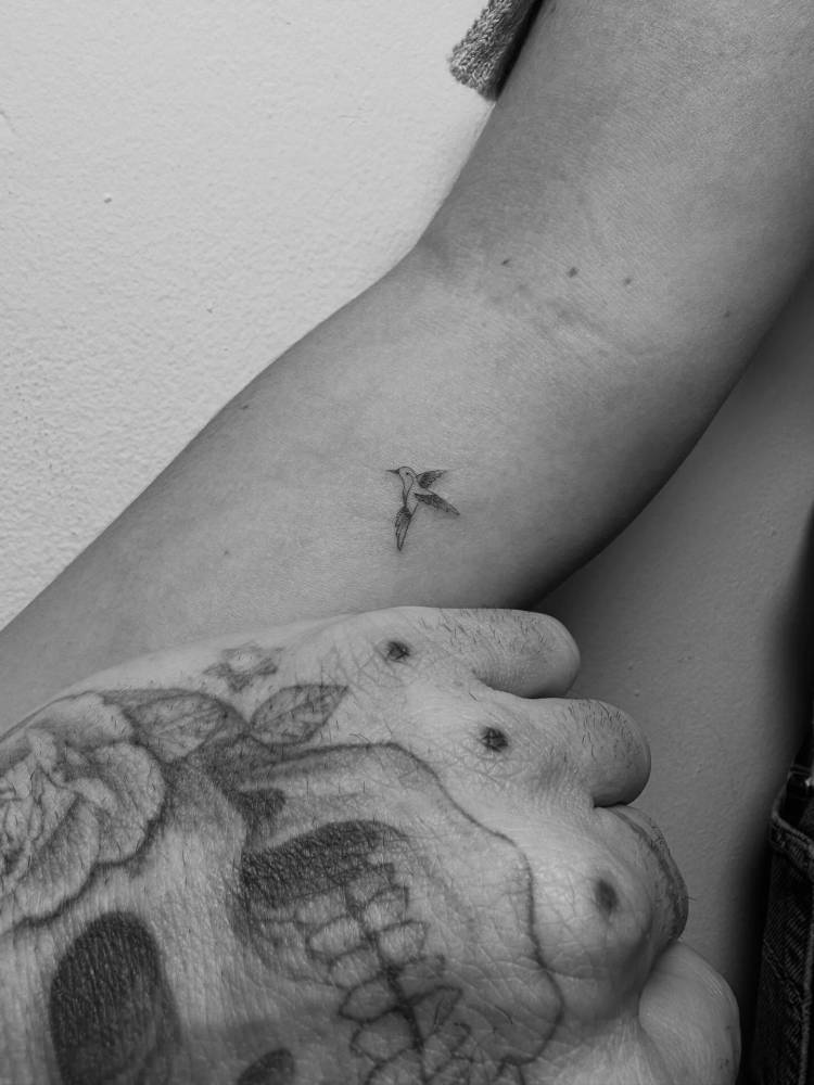 Tiny hummingbird tattoo located on the inner forearm.