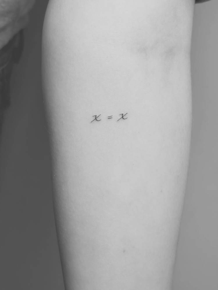 Little equation tattoo located on the inner forearm, minimalist style.