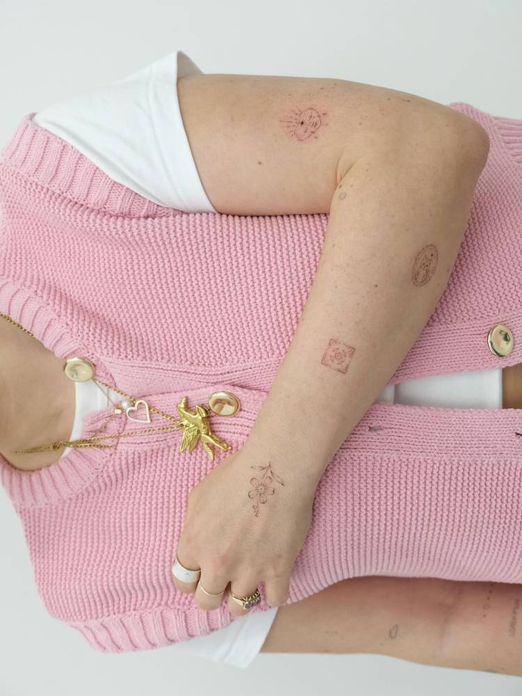 Arm composition tattoos in fine line style.