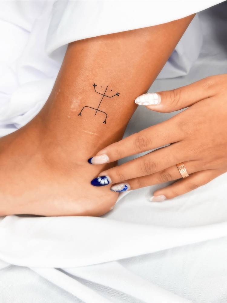 Minimalist style coqui tattoo located on the ankle.