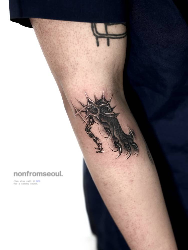 Oriental style paw tattoo located on the forearm.