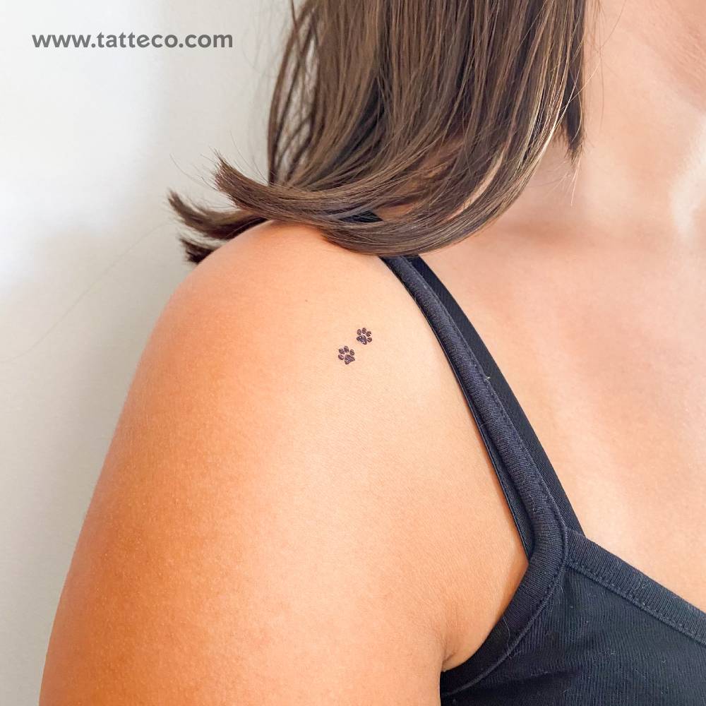 Tiny minimalist pawprint Couple temporary tattoo located on the shoulder.