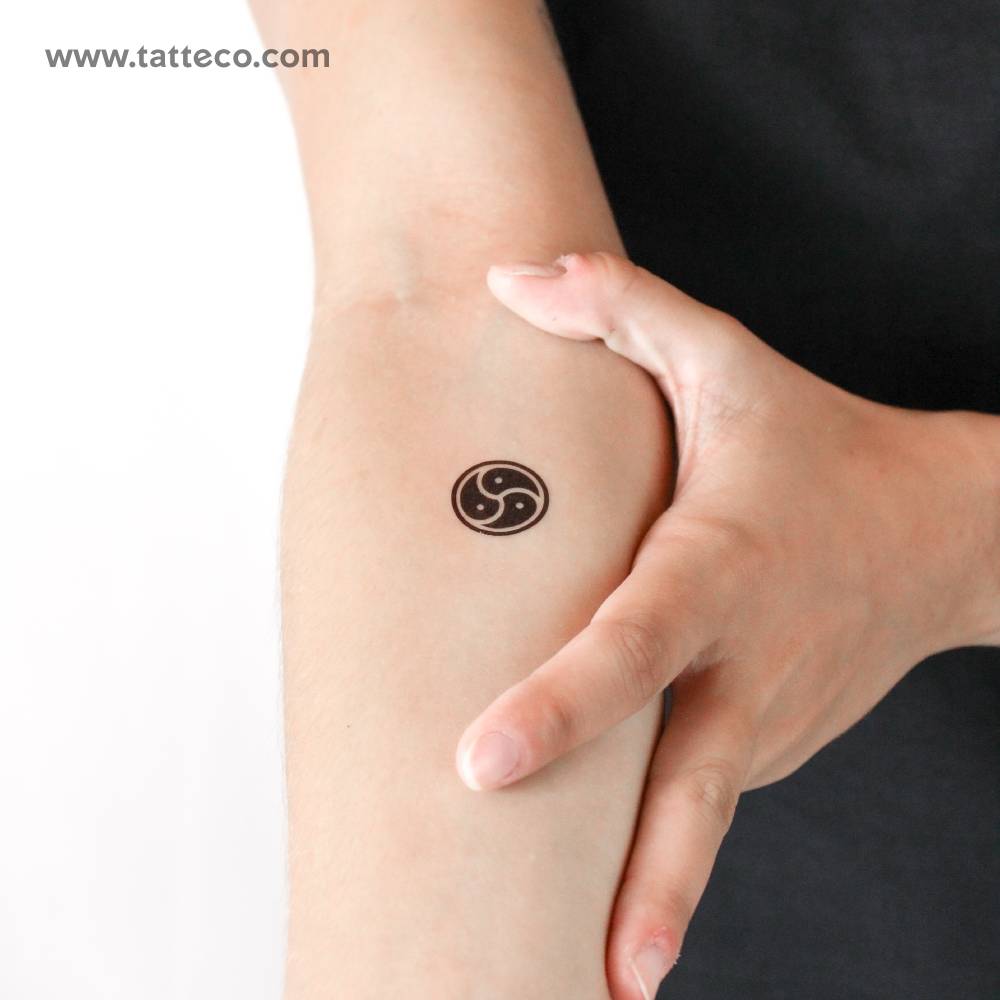 BDSM triskele temporary tattoo located on the inner forearm.