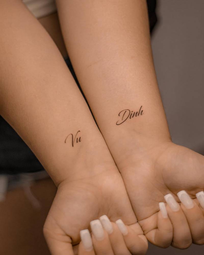 Individual matching names tattooed on the wrist.