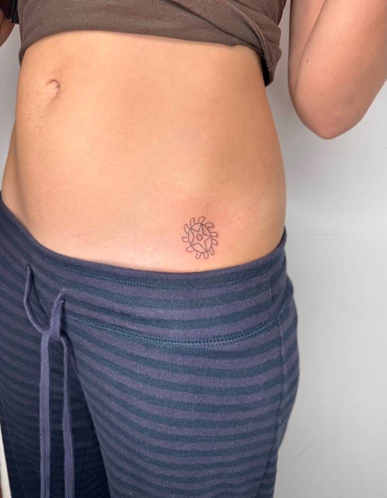 Fine line style Sesa Wo Suban symbol tattooed on the hip.