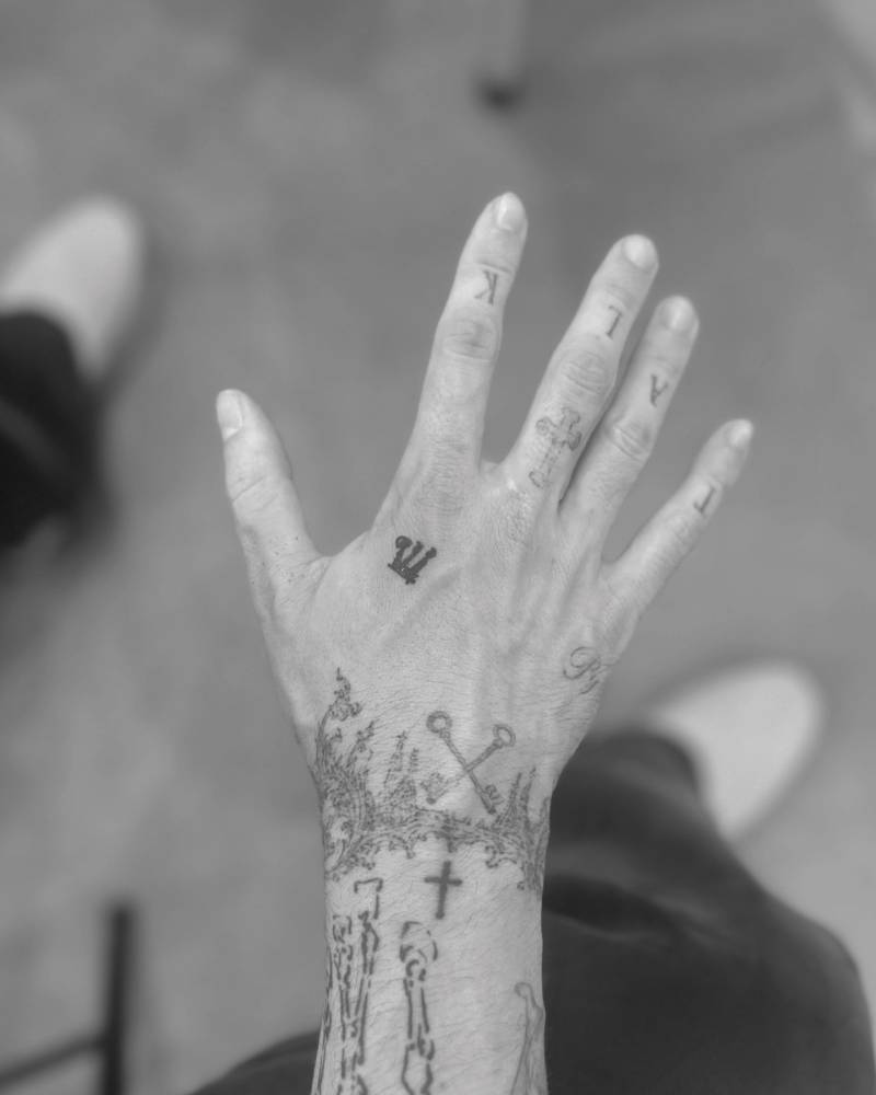 Minimalist symbol tattoo located on the hand.