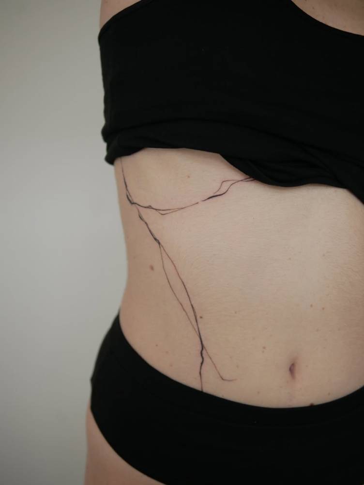 Leaves tattoo located on the rib.