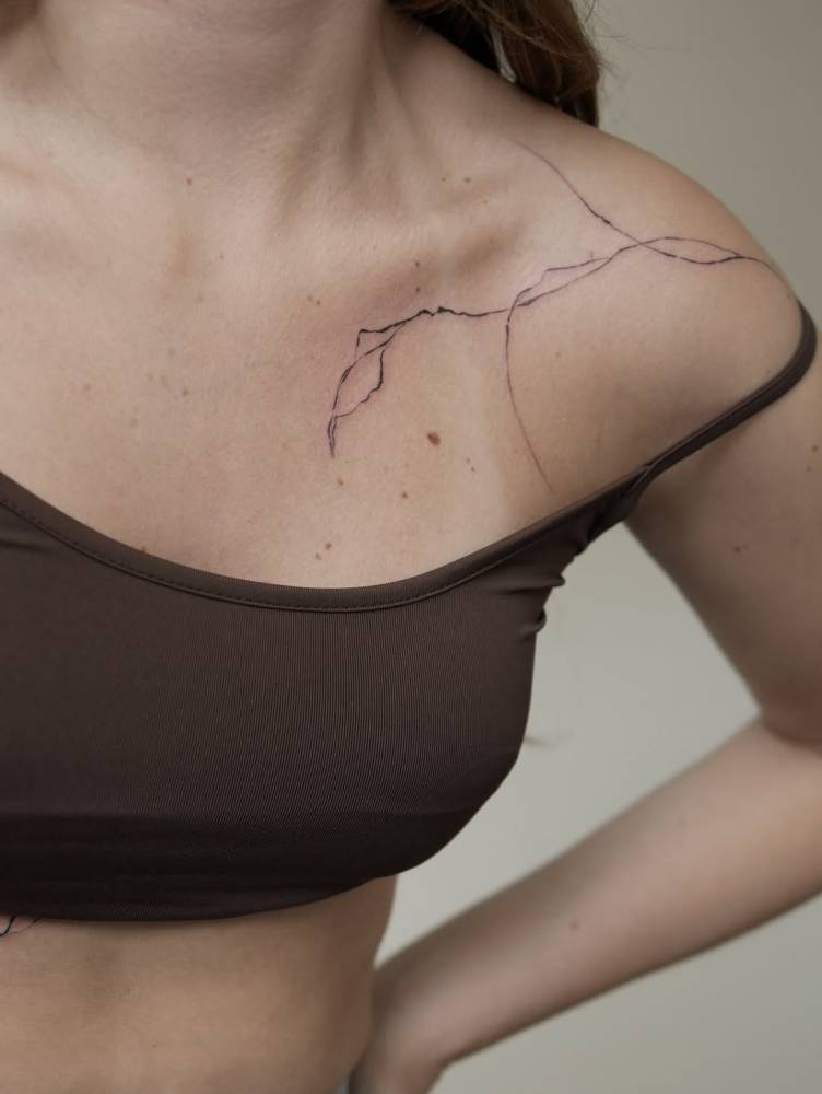 Illustrative style leaves tattoo located on the shoulder.