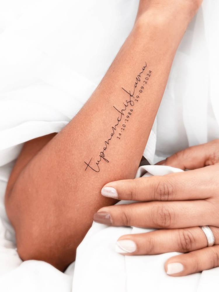 "Tupananchiskama" and dates tattoo located on the forearm.