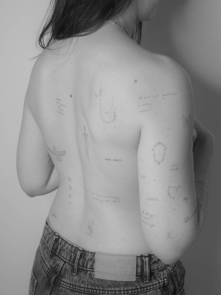 BAck composition tattoos in fine line style.