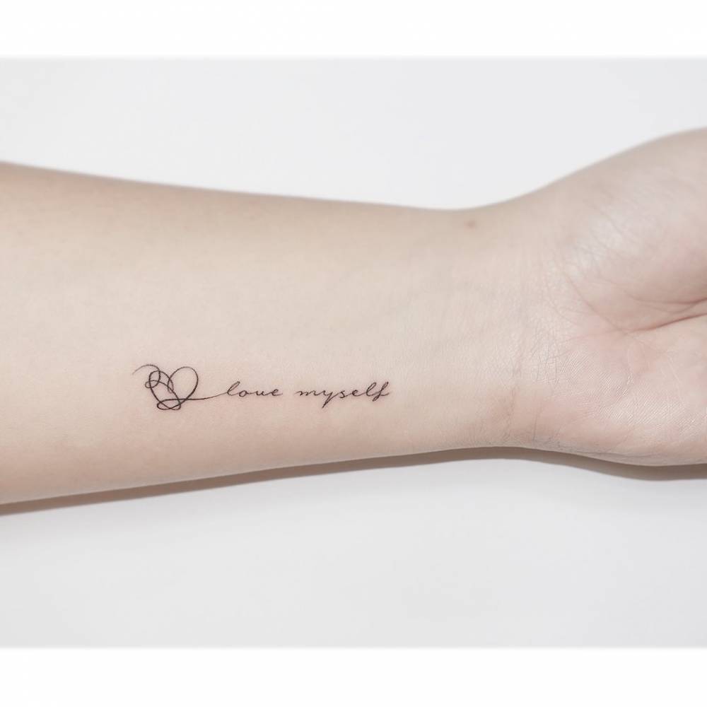 "Love myself" and BTS heart tattoo located on the wrist.