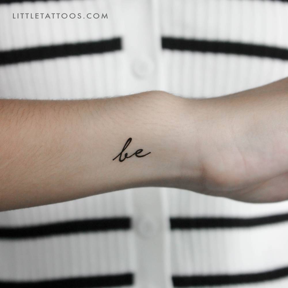 Word "be" temporary lettering tattoo located on the finger.
