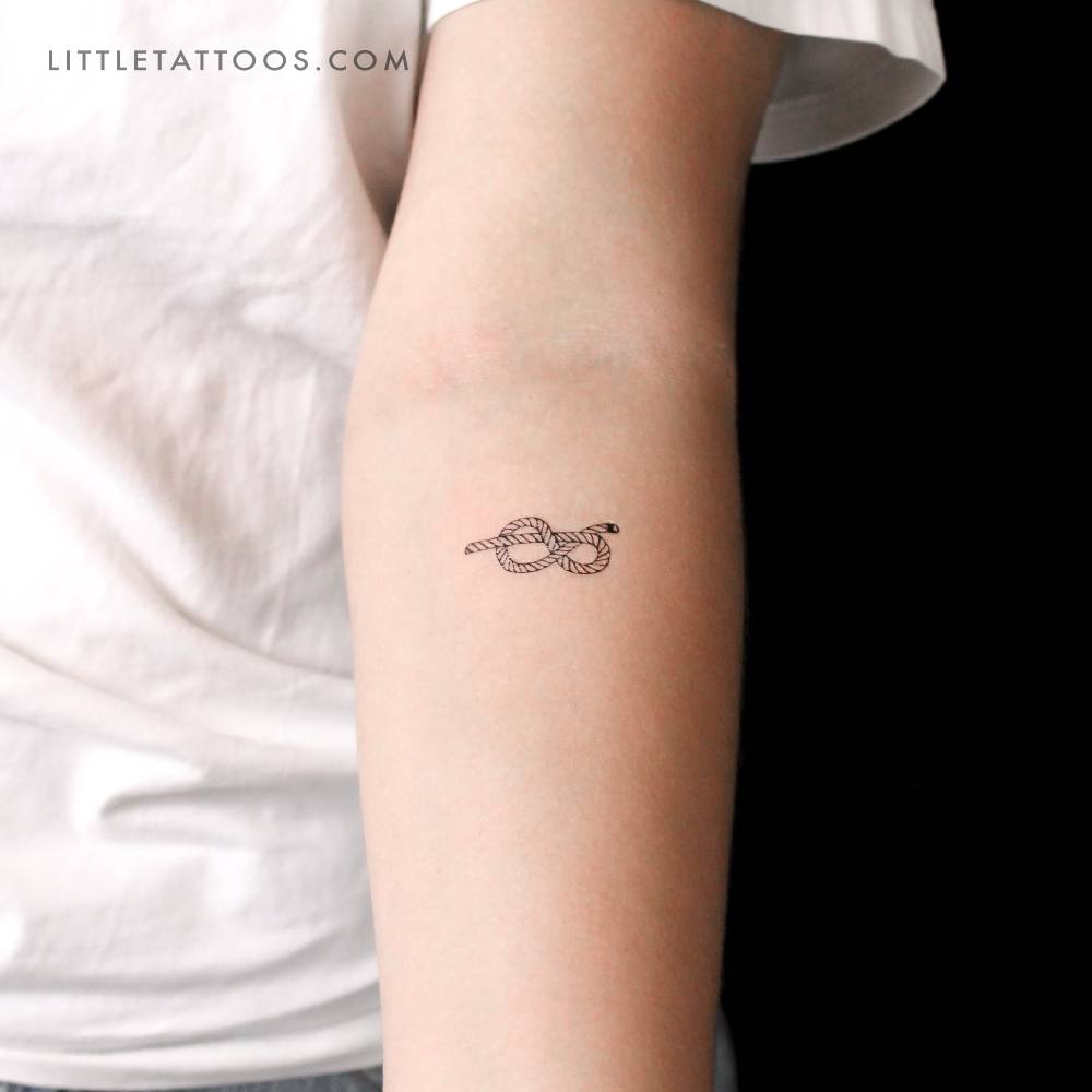 Figure-eight knot temporary tattoo located on the inner forearm.