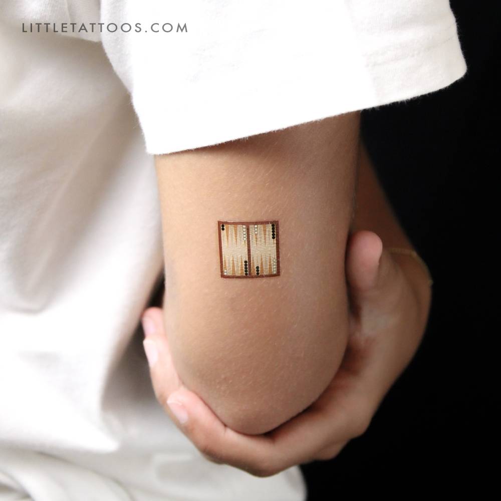 Backgammon temporary tattoo located on the tricep.