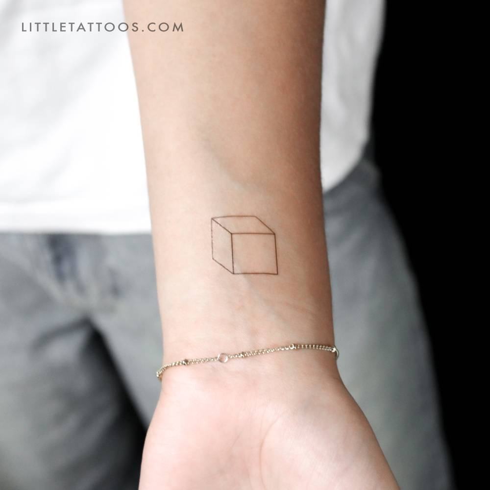 Little cube temporary tattoo located on the wrist.