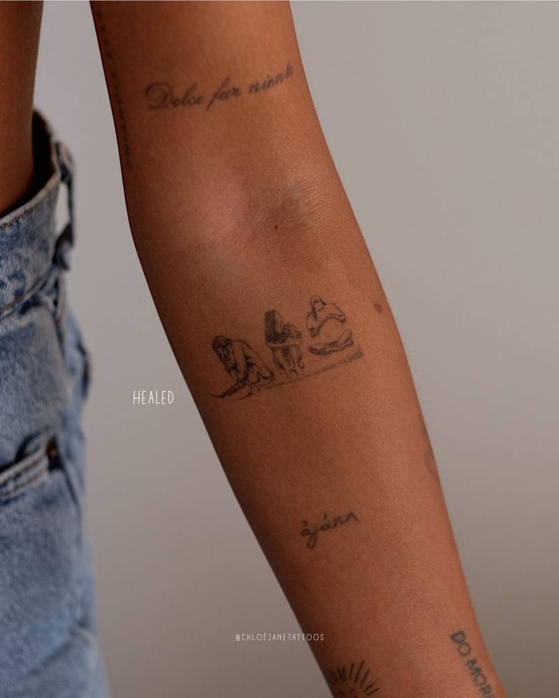 Healed friendship tattoo located on the inner forearm, illustrative style.