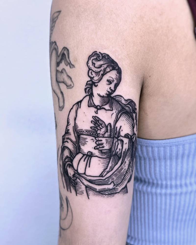 Tiburtine Sibyl tattoo located on the tricep, engraving style.