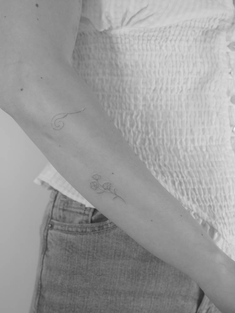 Flowers tattoo located on the forearm, done in fine line style.