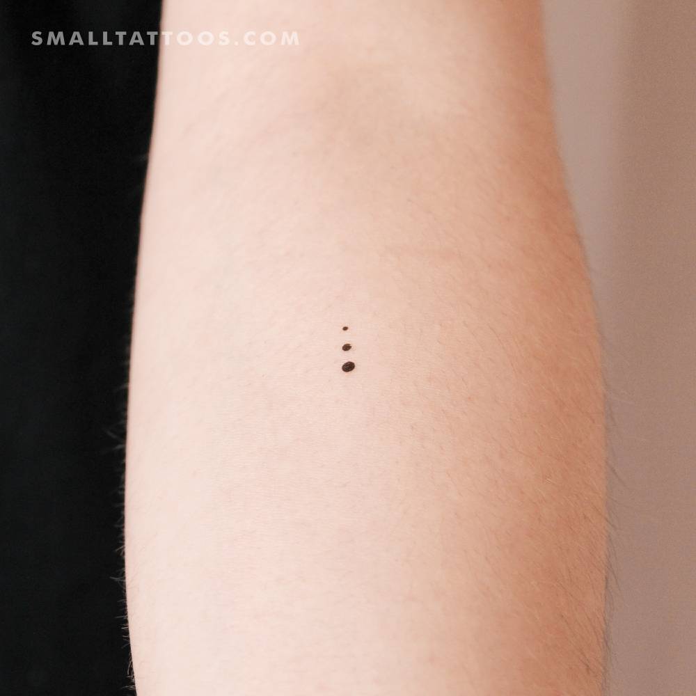 Growing dots temporary tattoo located on the inner forearm.
