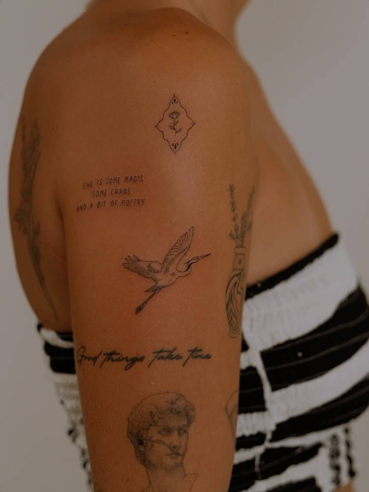 Heron tattoo in illustrative style located on the upper arm.