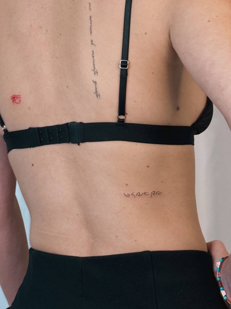Baybayin lettering tattooed on the lower back.