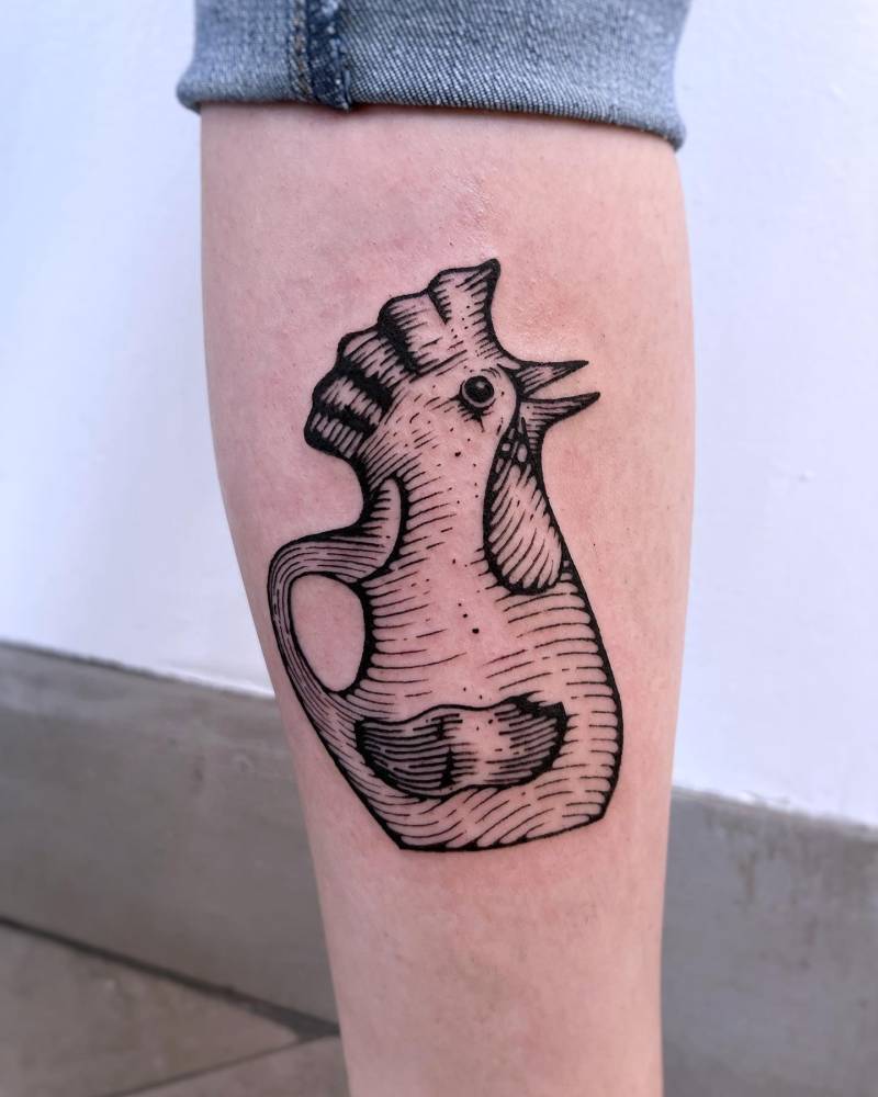 Chicken decoration featured on the film 'Brick' tattooed on the calf.