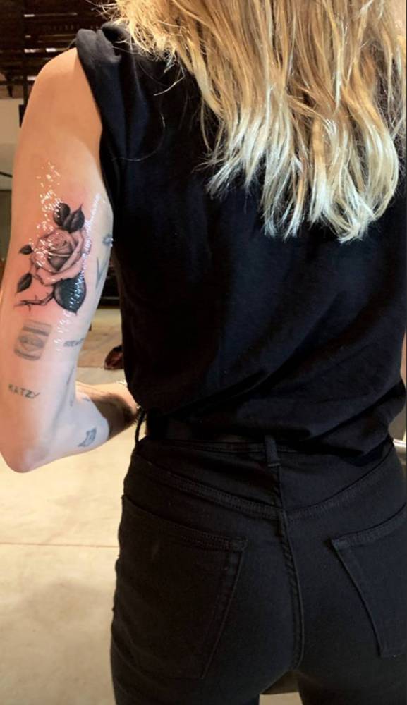 Rose tattoo located on MIley Cyrus' tricep.