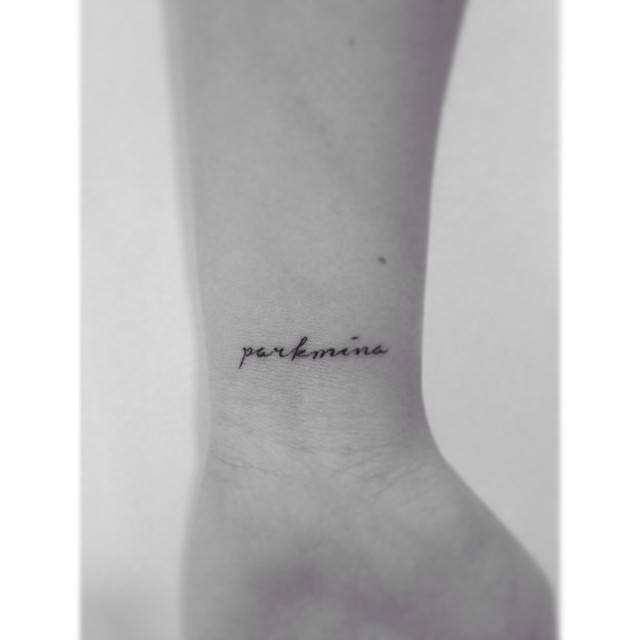 Name tattoo in script font located on the wrist.