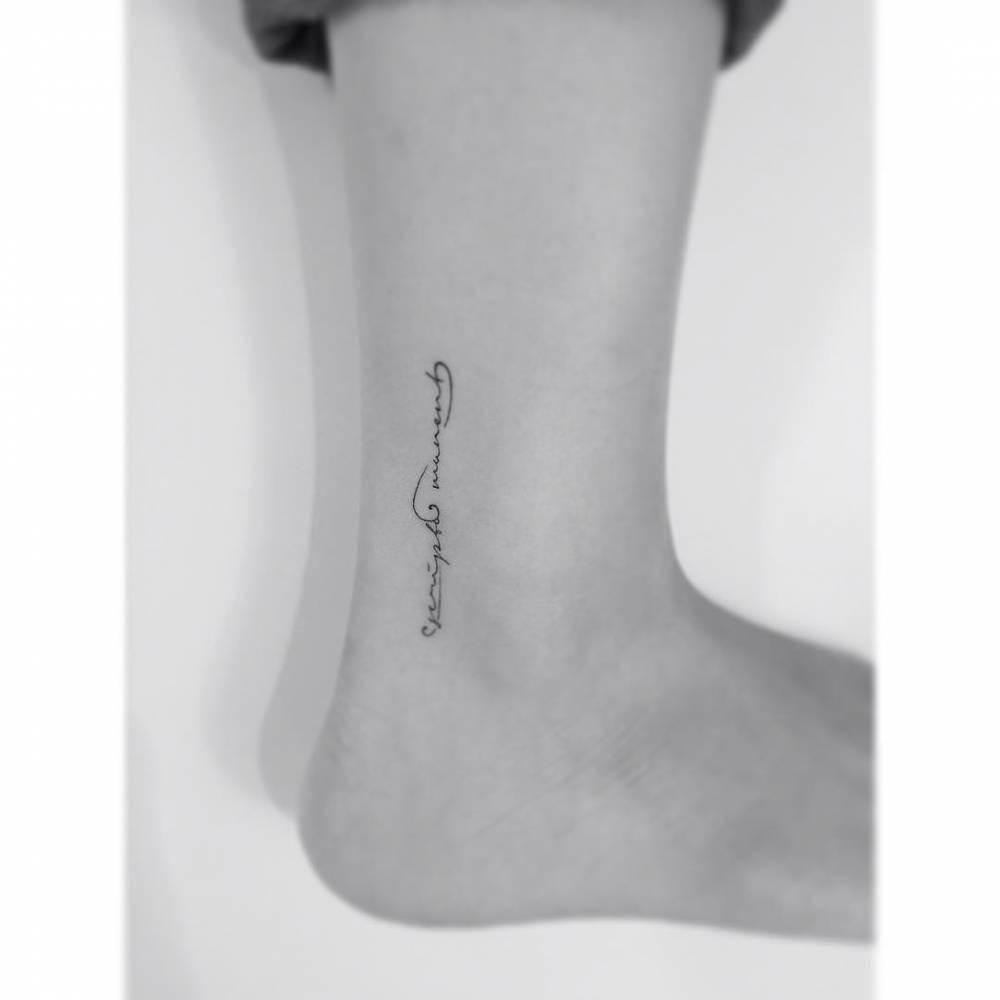 Treble clef lettering tattoo located on the ankle.