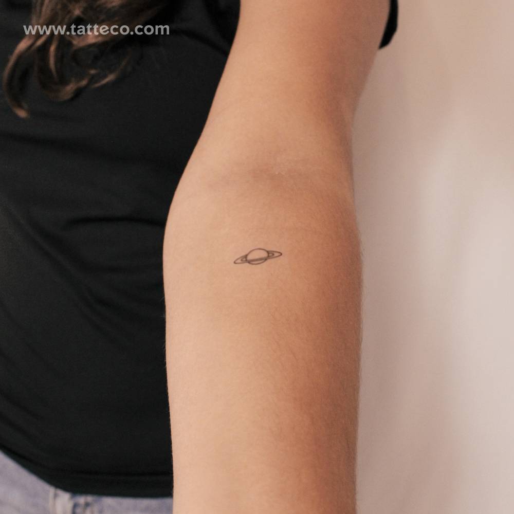 Saturn semi-permanent tattoo in minimalist style.
