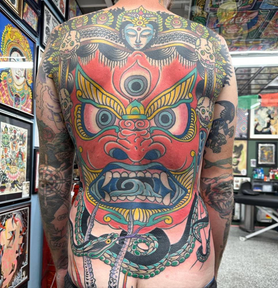 Hannya mask backpiece tattoo in oriental style.